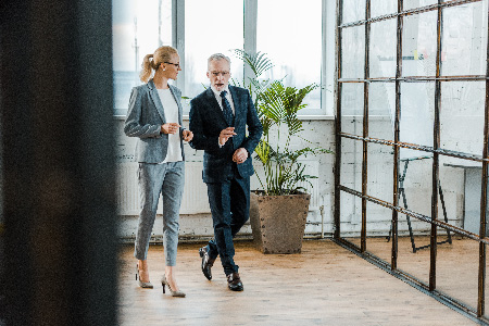 man_and_woman_walking_in_office
